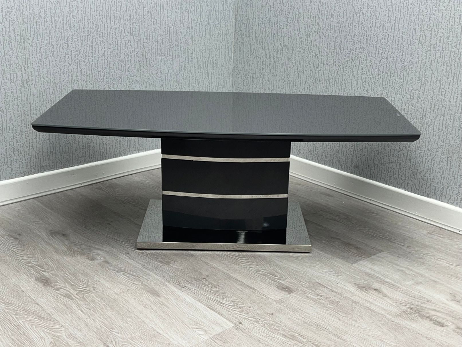 Milan Black High Gloss Coffee Table with chrome-trimmed layered pedestal base - front view